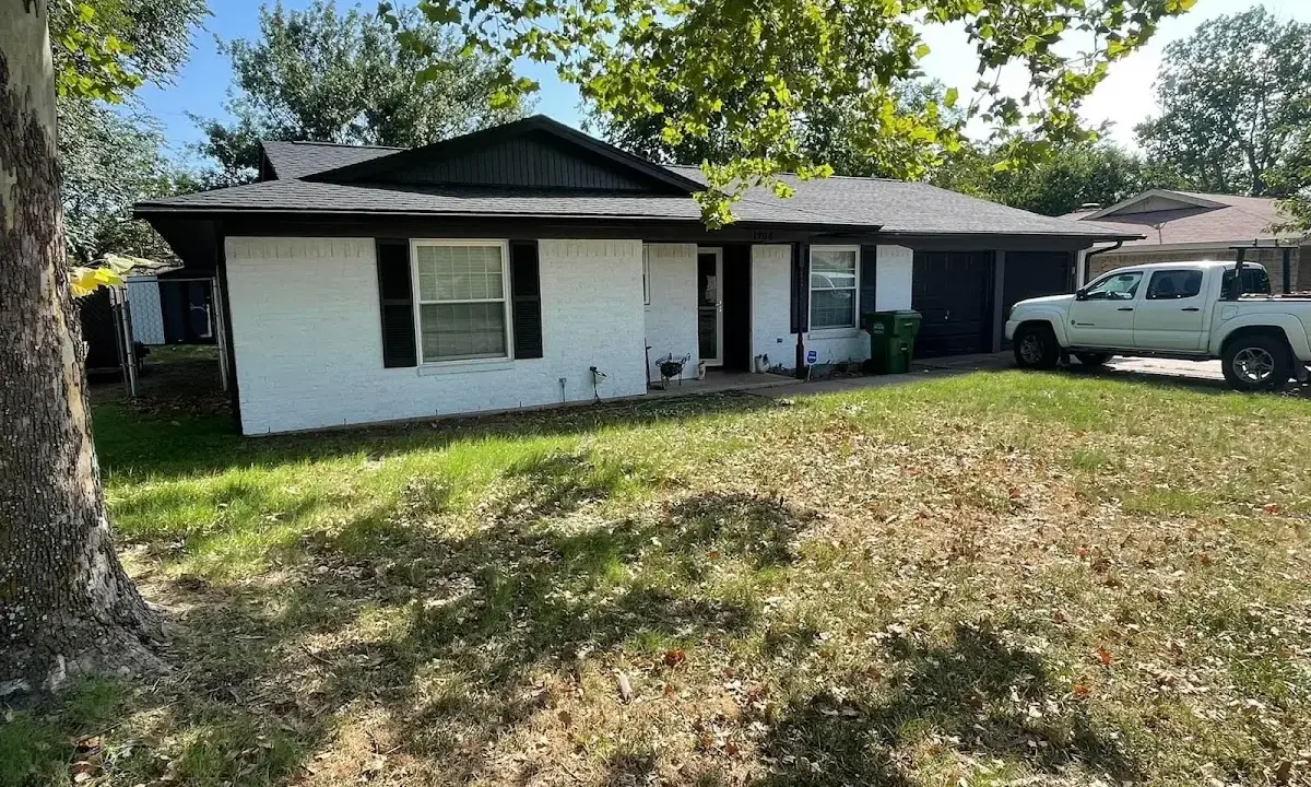 Professional roofing crew working on a residential roof in Almont